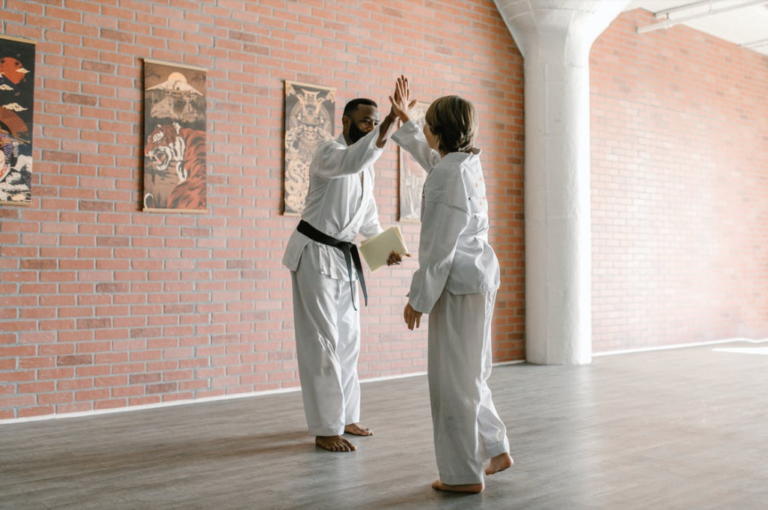 karate student high-fiving his instructor