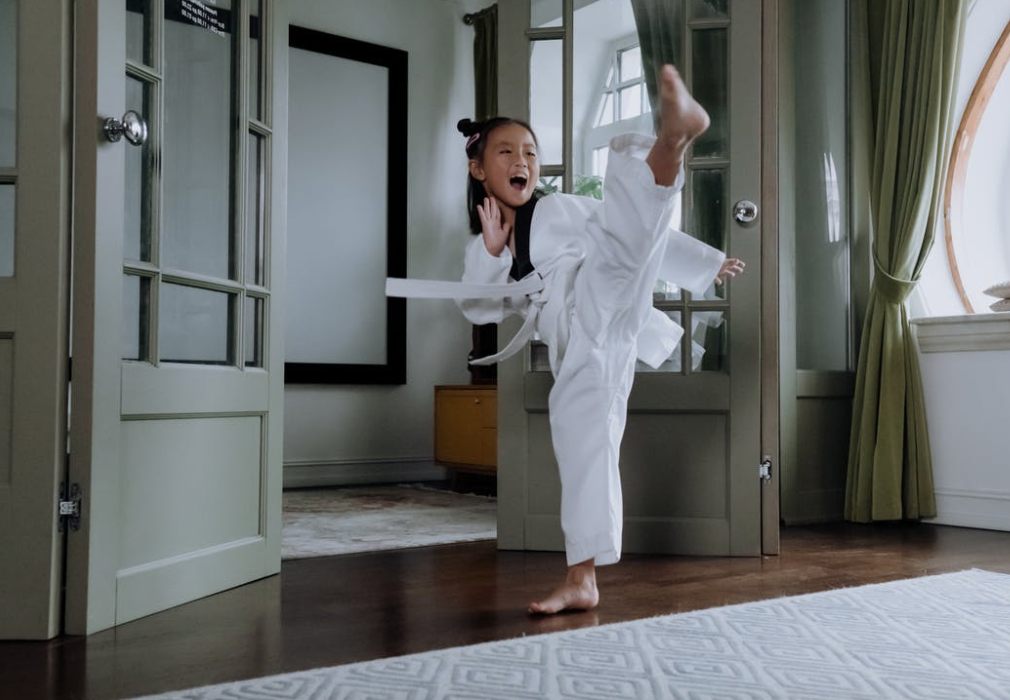 girl performing a karate kick