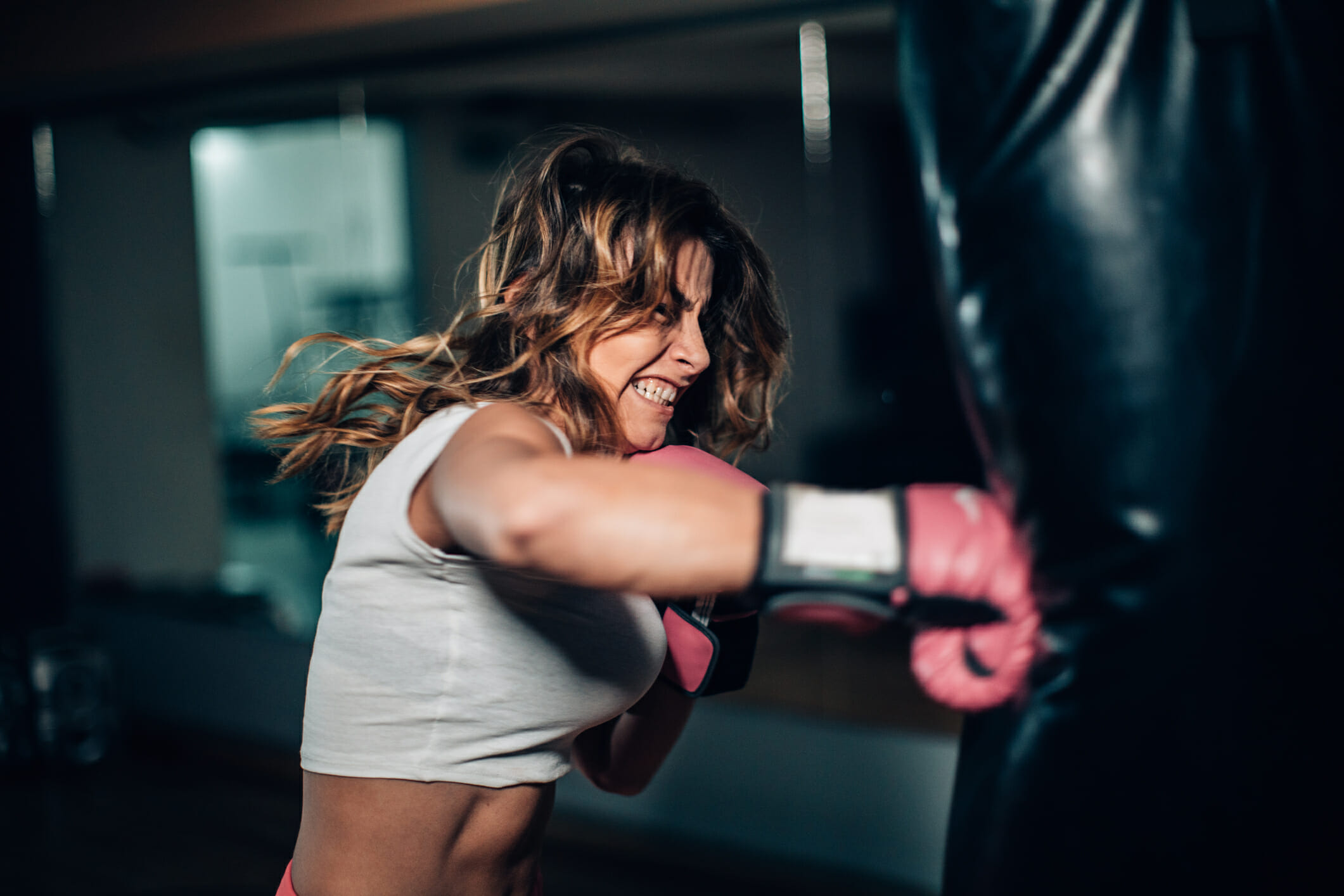 Woman boxer punching a punching bag