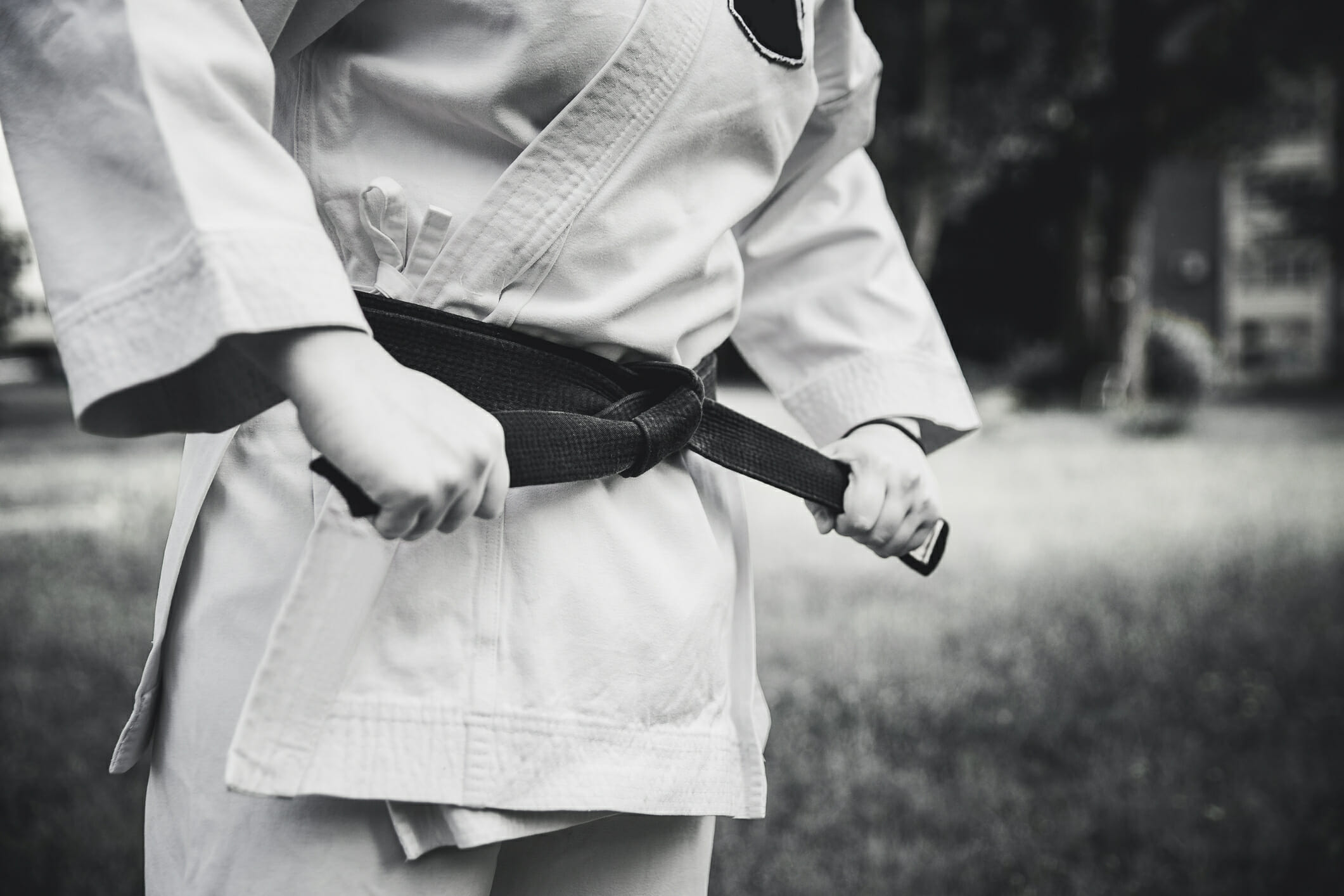 Female fighter tightening karate belt