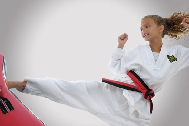 A teen doing a Karate side kick