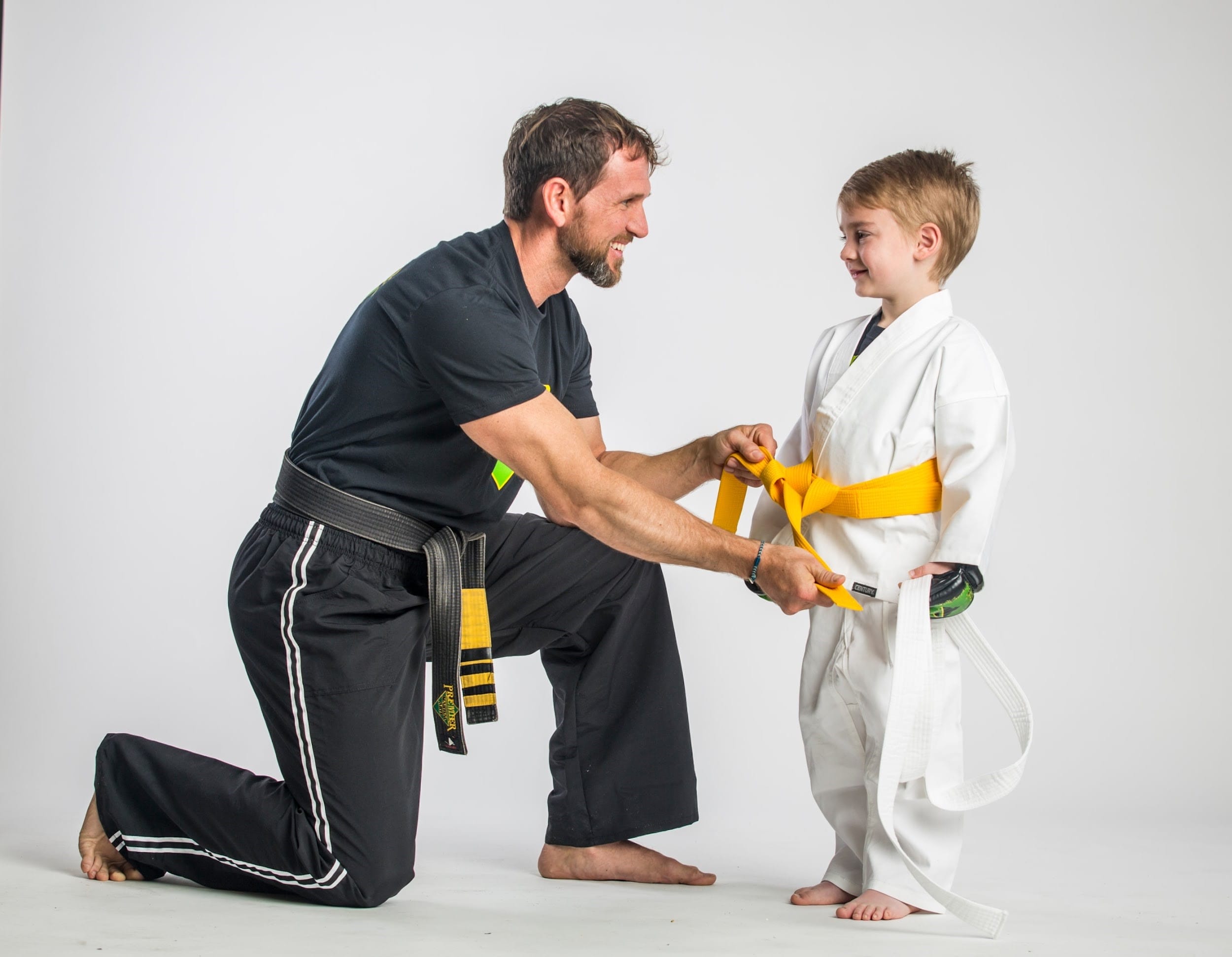 Coach and yellow belt kids martial arts student at premier martial arts